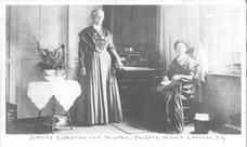 SA0013.1 - Sisters Catherine, on the right, and  Martha, on the left.  Photo shows an interior with a desk. Caption on the front., Winterthur Shaker Photograph and Post Card Collection 1851 to 1921c